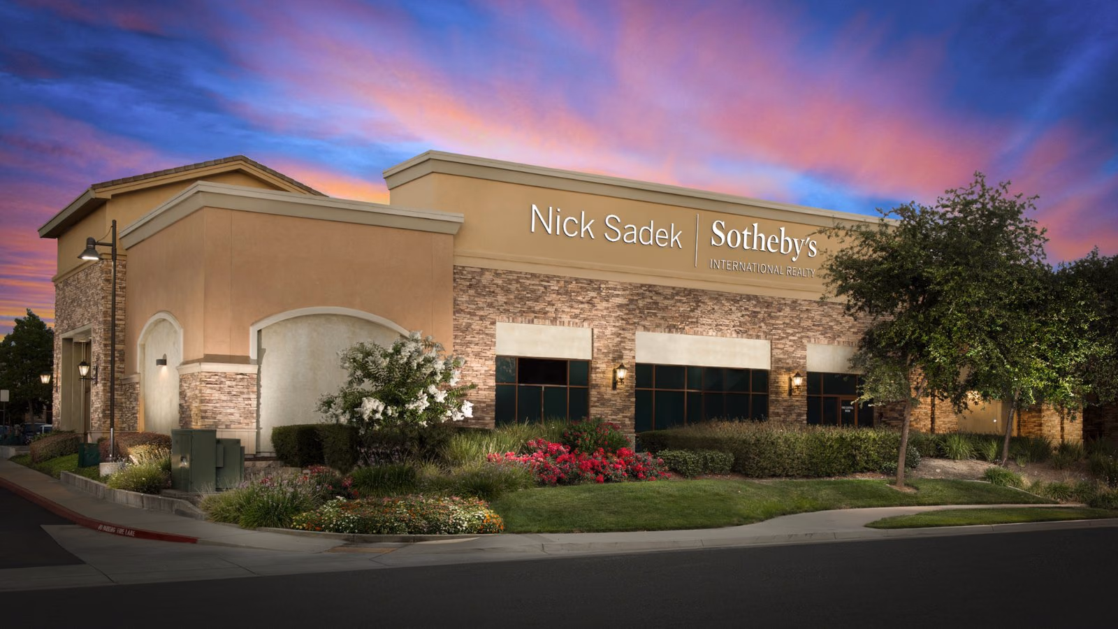 The Nick Sadek Sotheby’s International Realty office on Sierra College Boulevard in Roseville at dusk
