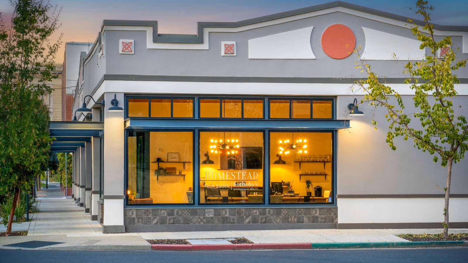 The Woodland office storefront on College Street at dusk